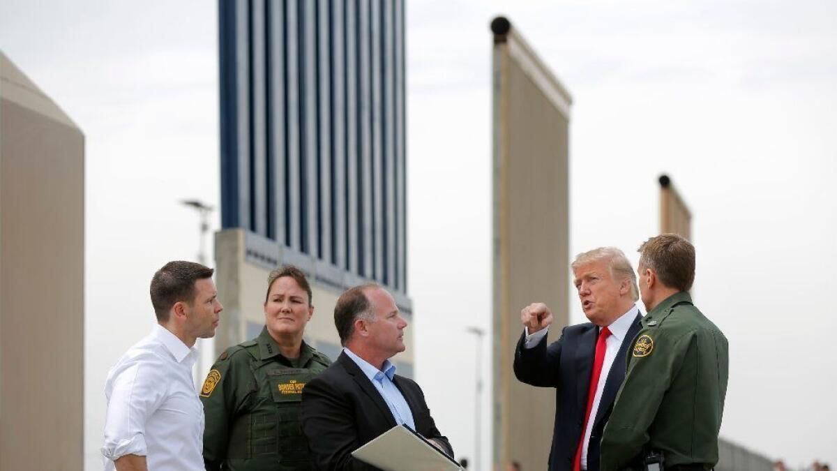 President Trump examines prototypes for border walls near San Diego in March.