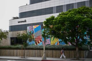 The WeWork logo is displayed outside of a shared commercial office space building in Los Angeles, California on August 8, 2023. Embattled office-sharing firm WeWork on August 8 warned US regulators that it is worried about its survival. Citing financial losses, cash needs, and a drop in memberships, WeWork said in a filing with the Securities and Exchange Commission (SEC) that "substantial doubt exists about the company's ability to continue as a going concern." (Photo by Patrick T. Fallon / AFP) (Photo by PATRICK T. FALLON/AFP via Getty Images)