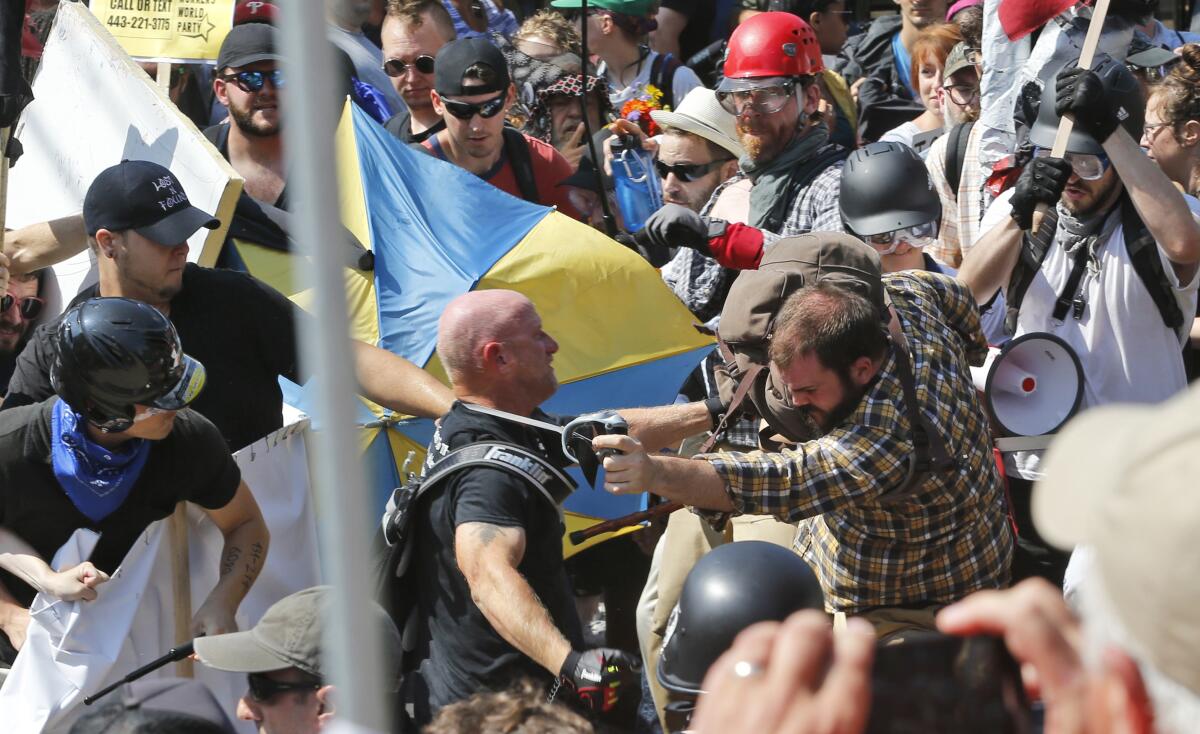 In this Aug. 12, 2017, file photo, white nationalist demonstrators clash with counterprotesters in Charlottesville, Va.