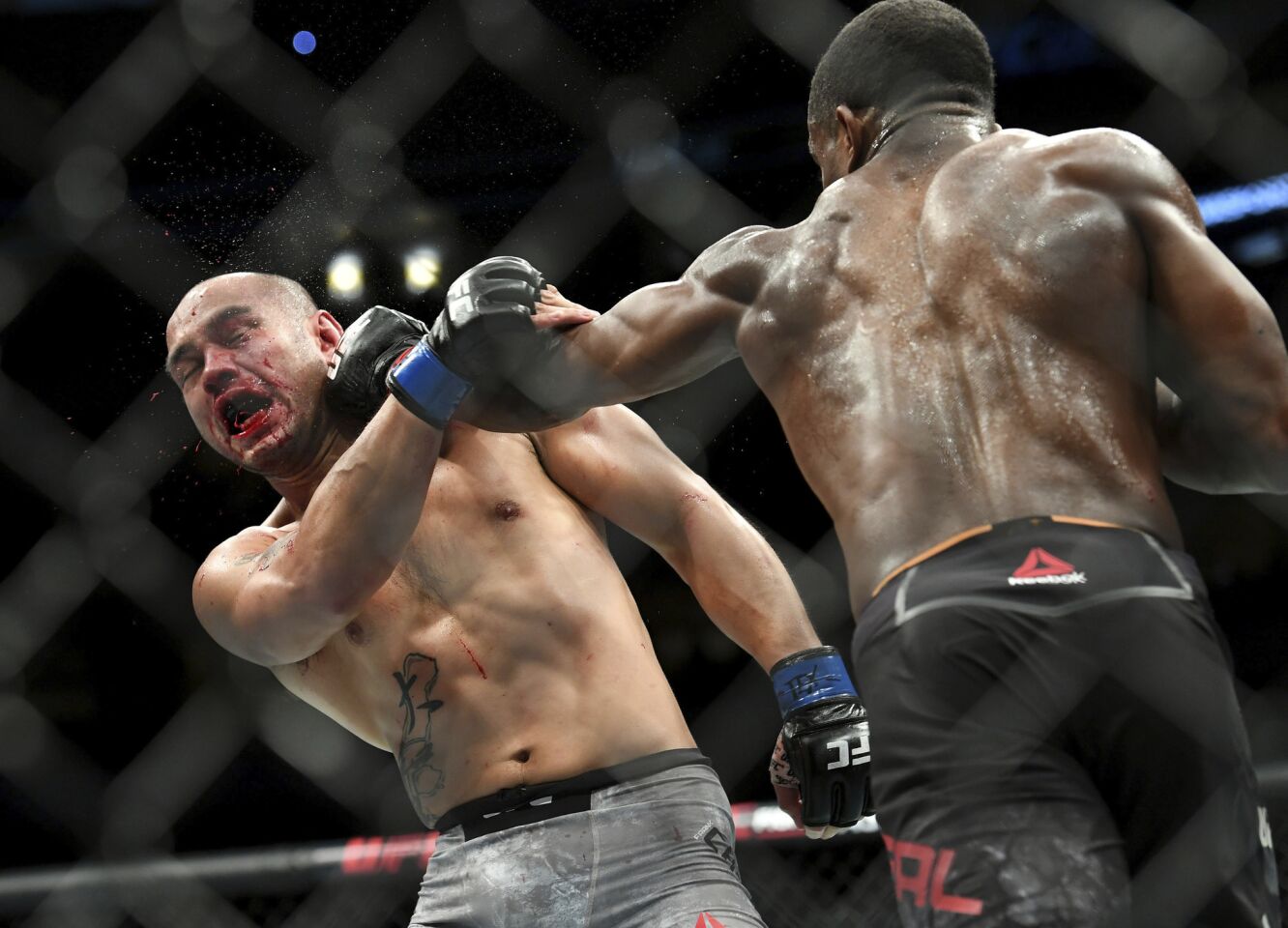 Frank Camacho, left, is hit by Geoff Neal during their welterweight mixed martial arts bout at UFC 228 on Saturday, Sept. 8, 2018, in Dallas. (AP Photo/Jeffrey McWhorter)