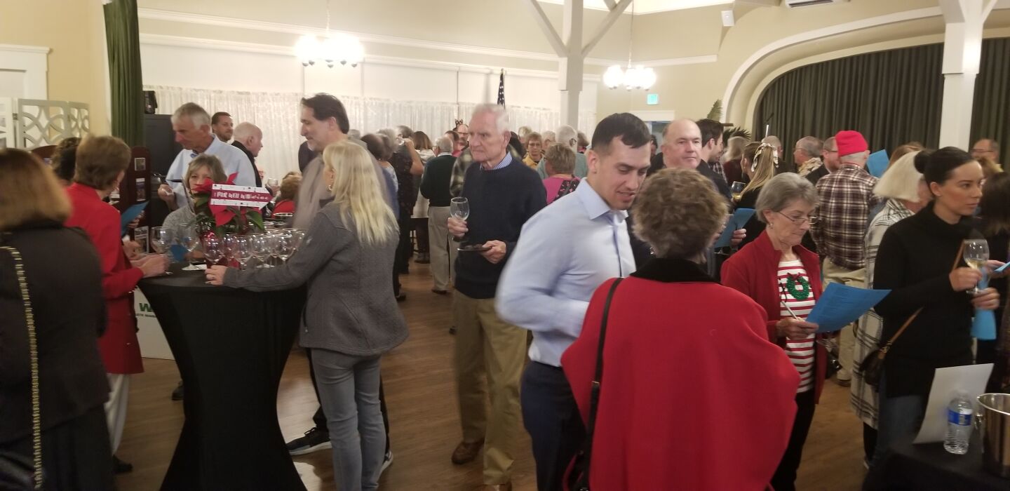 Wine-lovers and connoisseurs pack the Point Loma Assembly hall for Jensen’s wine-tasting event.