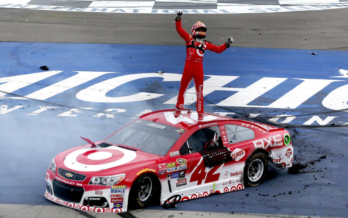 Kyle Larson, driver of the #42 Target Chevrolet, celebrates after winning the NASCAR Sprint Cup Series Pure Michigan 400 at Michigan International Speedway.