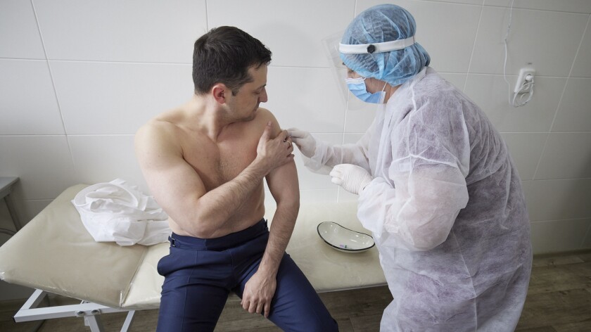 In this handout photo provided by the Ukrainian Presidential Press Office, Ukrainian President Volodymyr Zelensky receives a dose of the AstraZeneca vaccine, marketed under the name CoviShield, as he visits the war-hit Luhansk region, eastern Ukraine, Tuesday, March 2, 2021. (Ukrainian Presidential Press Office via AP)