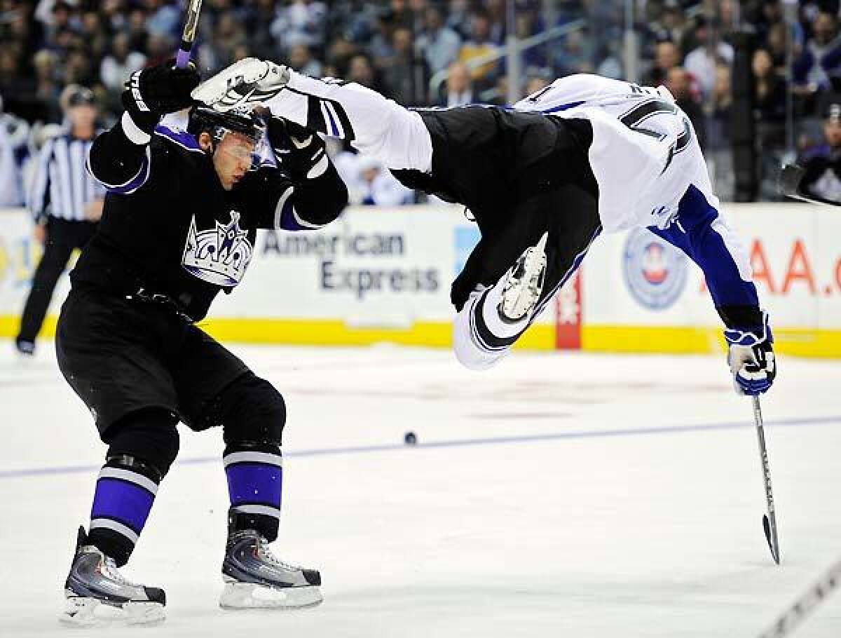 Tampa Bay Lightning center Mattias Ritola is sent flying after tripping over Los Angeles Kings defenseman Jack Johnson during the second period of an NHL game on Thursday.