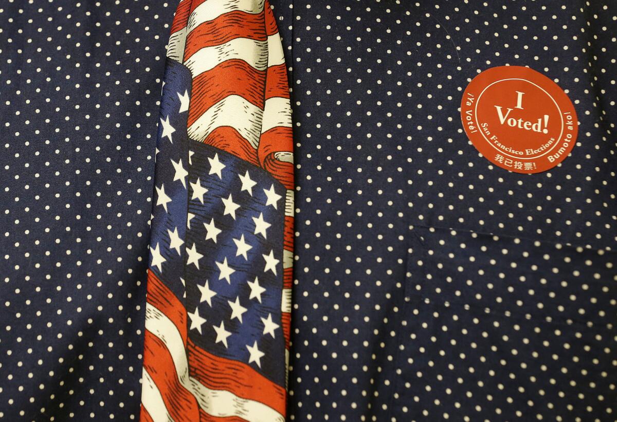 Leo Samuelson wears an American flag tie and a sticker while working at San Francisco City Hall's elections office.