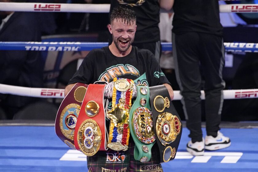 FILE - Josh Taylor celebrates while holding his belts after defeating Jose Ramirez by unanimous decision in a junior welterweight title boxing bout Saturday, May 22, 2021, in Las Vegas. Undefeated champion Josh Taylor faces Teofimo Lopez on Saturday, June 10, 2023, at Madison Square Garden in New York. (AP Photo/John Locher, File)