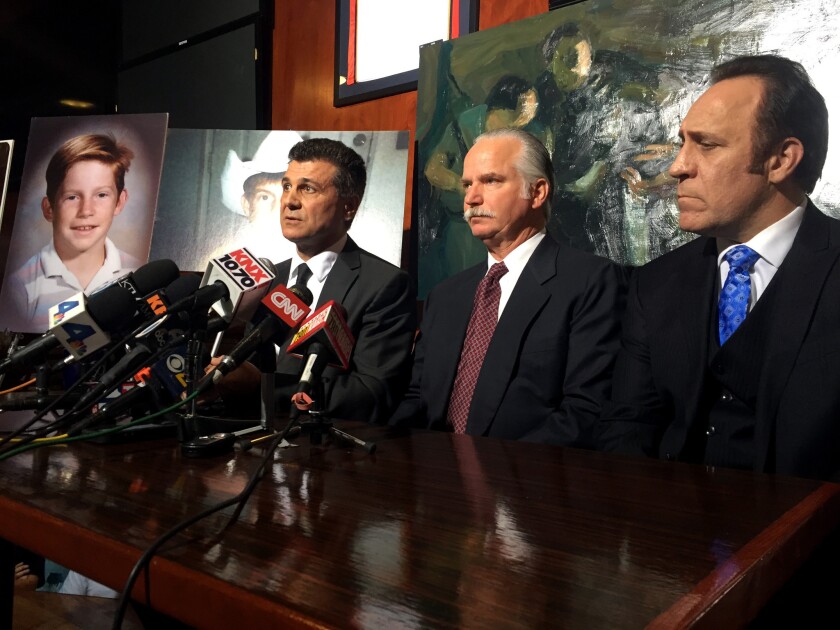Ron Thomas, center, is flanked by attorney's Garo Mardirossian, left and Dale Galipo during a press conference Monday after a $4.9-million settlement was reached in the death of Thomas' mentally ill homeless son, Kelly Thomas Monday, November 23, 2015. In 2011, Thomas, who suffered from schizophrenia, was beaten by Fullerton police when he wouldn't follow their commands. He died a few days later.