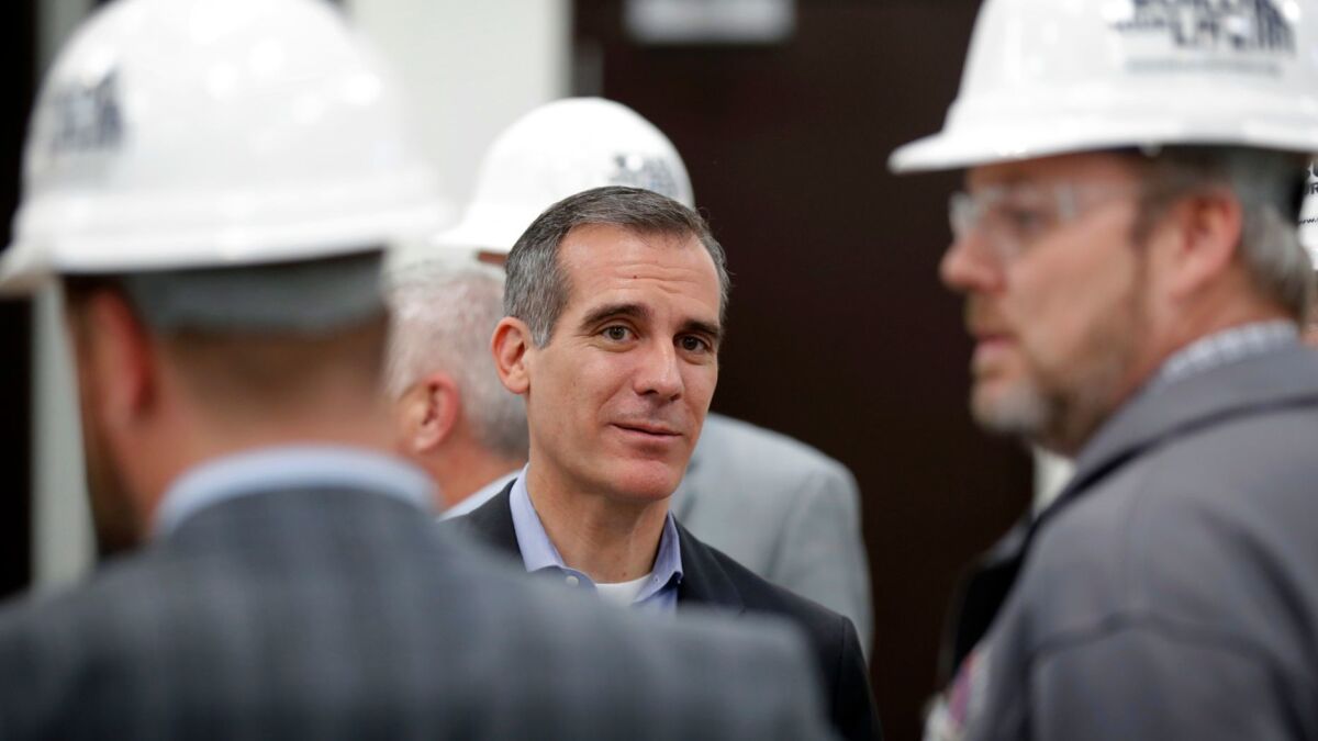 Mayor Eric Garcetti visits with staff during a tour of a carpenters training facility in Altoona, Iowa, on April 13.