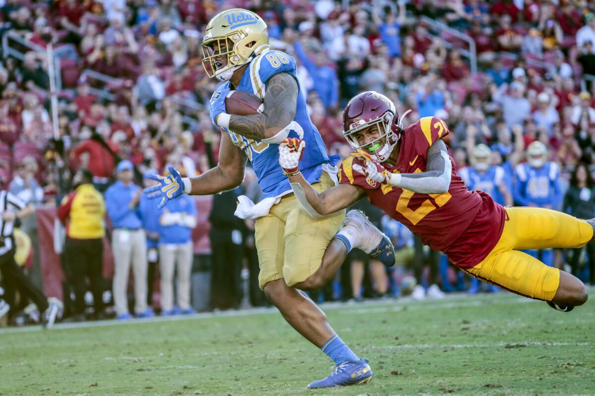 UCLA tight end Devin Asiasi runs with the ball against USC.