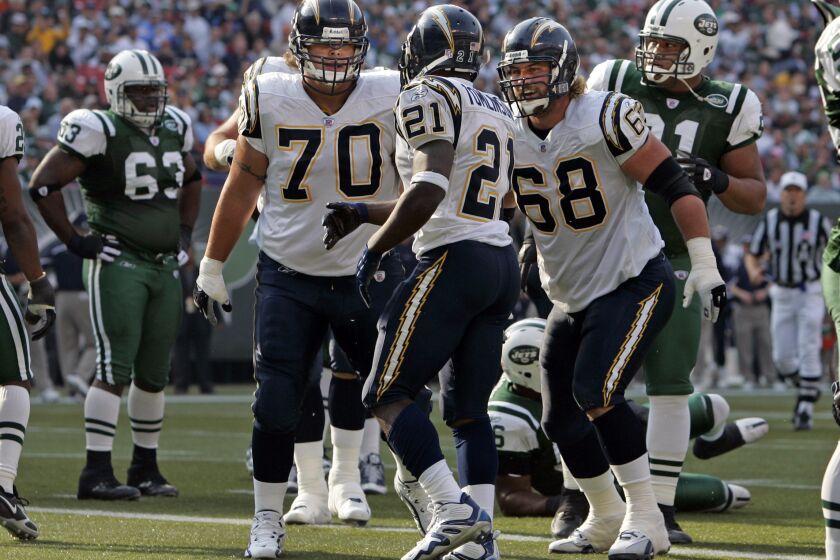 LaDainian Tomlinson celebrates 1st qtr touchdown with Shane Olivea and Kris Dielman 68 at the Meadowlands on Sunday, Nov. 6, 2005. Photo by K.C. Alfred U-T