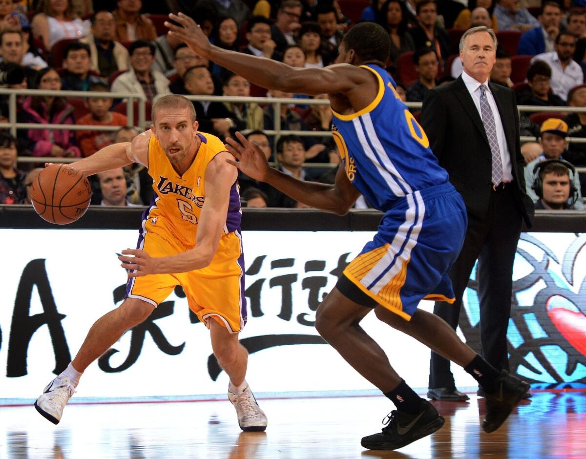 Lakers Coach Mike D'Antoni, right, watches guard Steve Blake, left, drive past Golden State's Tony Douglas during a preseason game in Beijing last week. D'Antoni appears to recognize that the Lakers lack the personnel to play at the ultra-fast pace for which his teams are known.