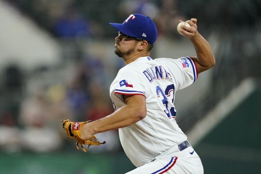 Texas Rangers starting pitcher Dane Dunning throws to a Los Angeles Angels batter during the first inning of a baseball game in Arlington, Texas, Wednesday, Sept. 21, 2022. (AP Photo/Tony Gutierrez)