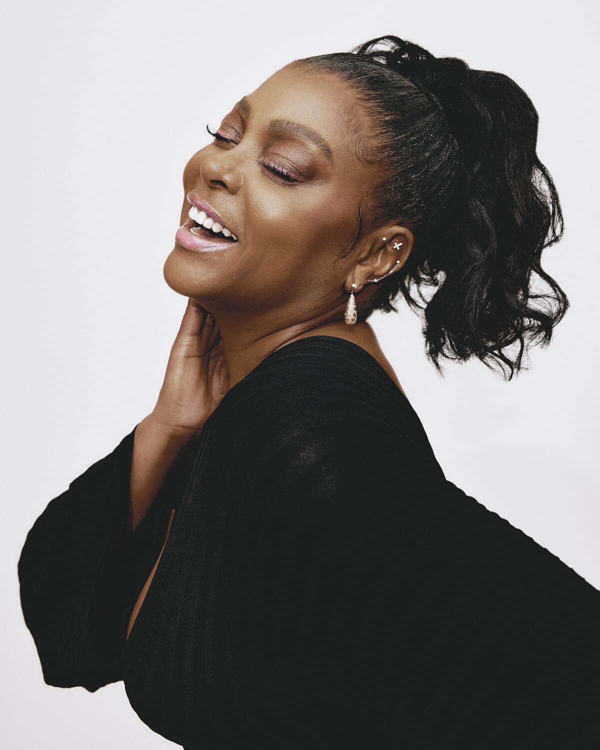 Taraji P. Henson closes her eyes as she laughs during a portrait shoot.