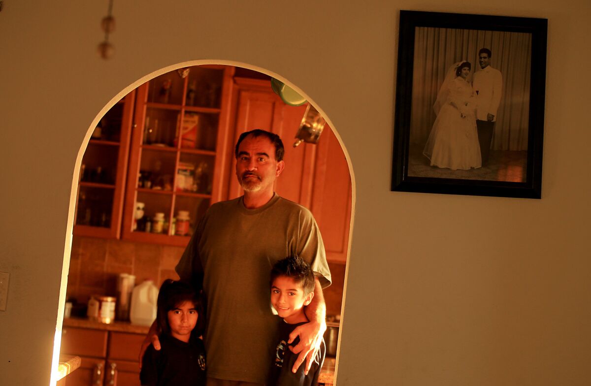 Martin Saldana with son Dimaggio and daughter Darlene. (Luis Sinco / Los Angeles Times)