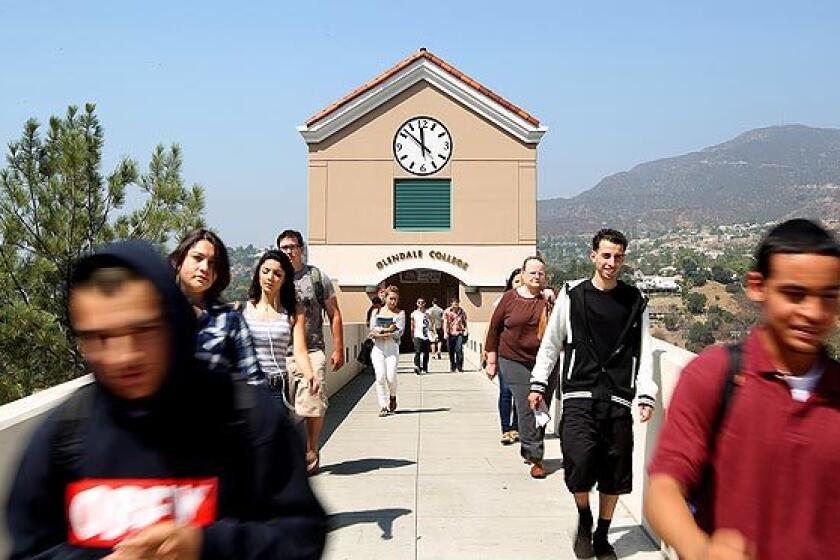Students walk along a bridge towards a parking structure at Glendale Community College. Students at California's community colleges are having a tough time getting into classes they need to further their careers.