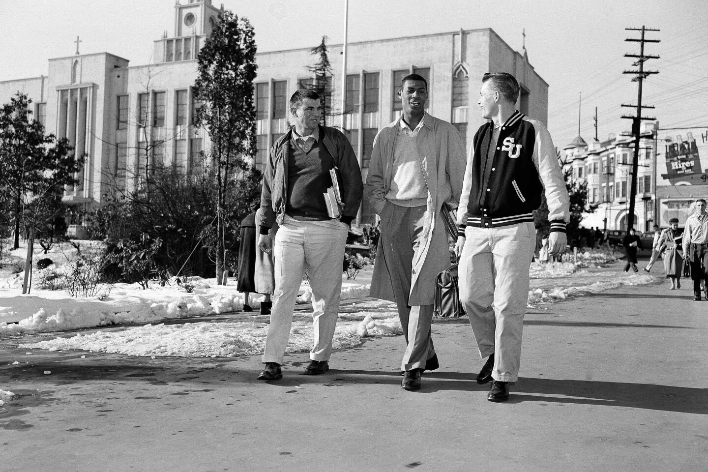 Baylor, center, walks on the Seattle University campus with classmates Jack Jones, left, and Craig Hanson on Feb. 1, 1957.