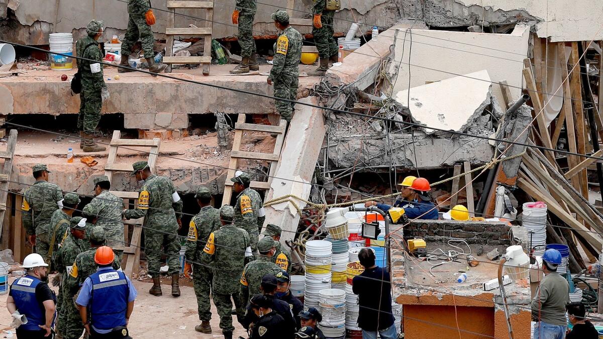 Notice how a concrete column snapped in half at the Enrique Rebsamen school in Mexico City. More reinforcing steel within the column would have prevented the concrete from snapping like a piece of chalk, and enabled it to flex when shaken side to side in an earthquake. (Gary Coronado / Los Angeles Times)