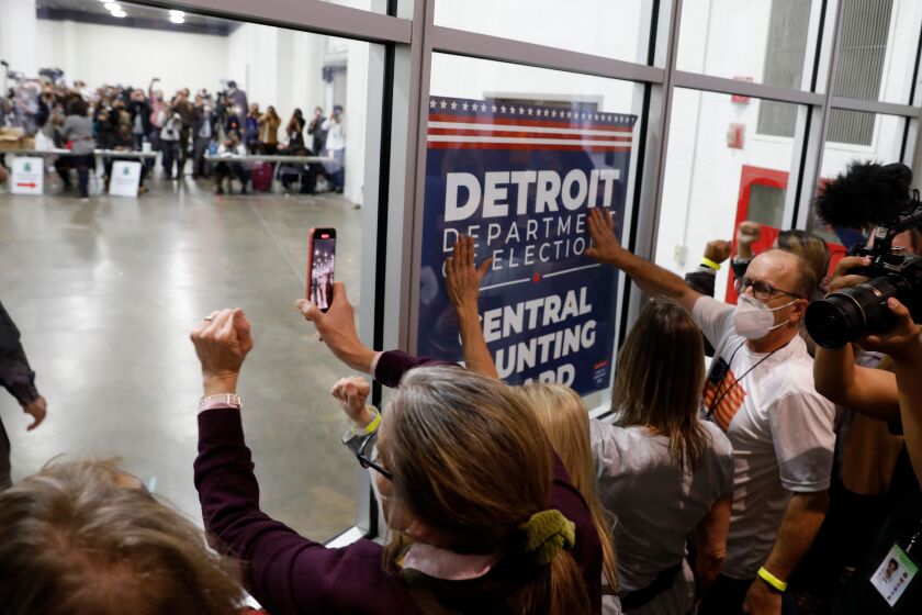 Supporters of Donald Trump outside a room.