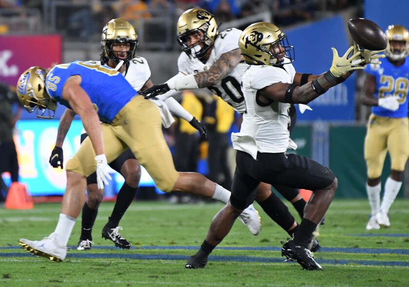 Colorado Security Mark Perry intercepts a transmission targeted for UCLA titan Greg Dulcic in the first quarter.