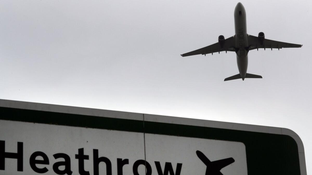 A plane takes off from Heathrow Airport in London. Police are investigating after suspicious packages were found, including one near Heathrow.