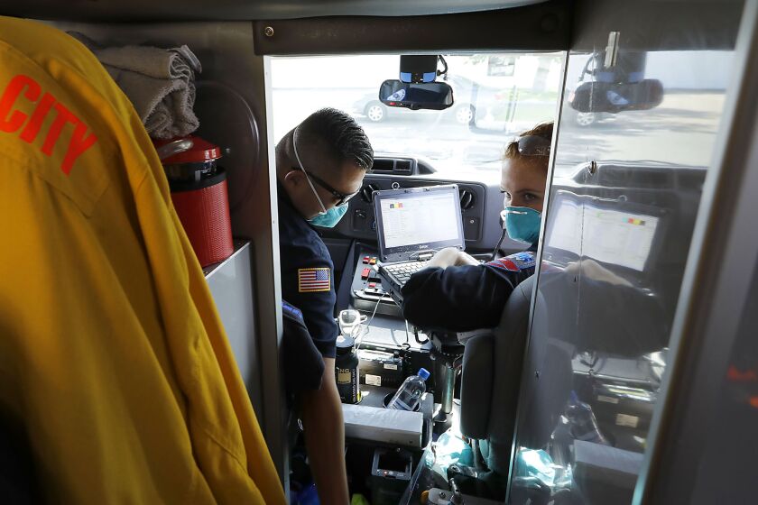 Alex Lu, left, and Rebecca Azetisian, here in their ambulance, both EMTs work out of AMR's Kearny Mesa location. San Diego has had the same ambulance provider for more than two decades. The city signed a deal in 1997 with Rural/Metro, and AMR took over the contract in 2015 when it bought Rural/Metro.