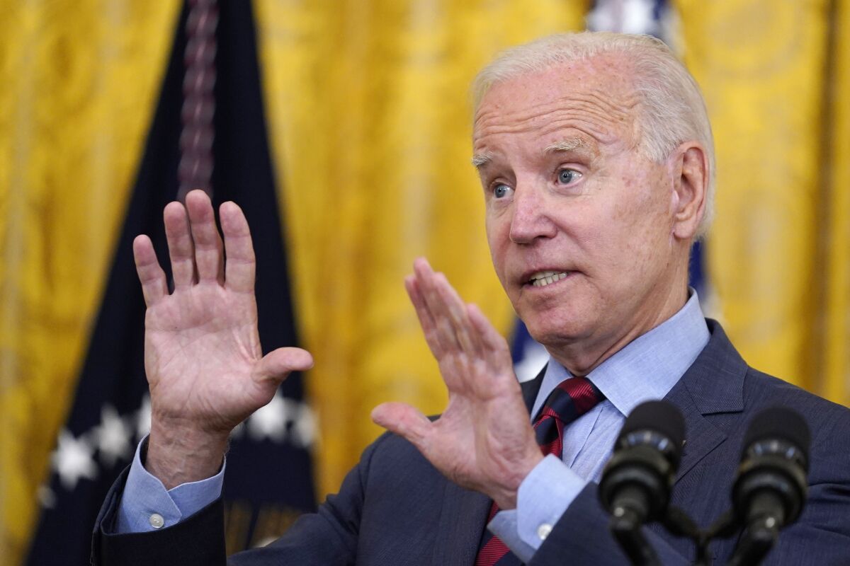 President Biden speaks, using his hands for emphasis.