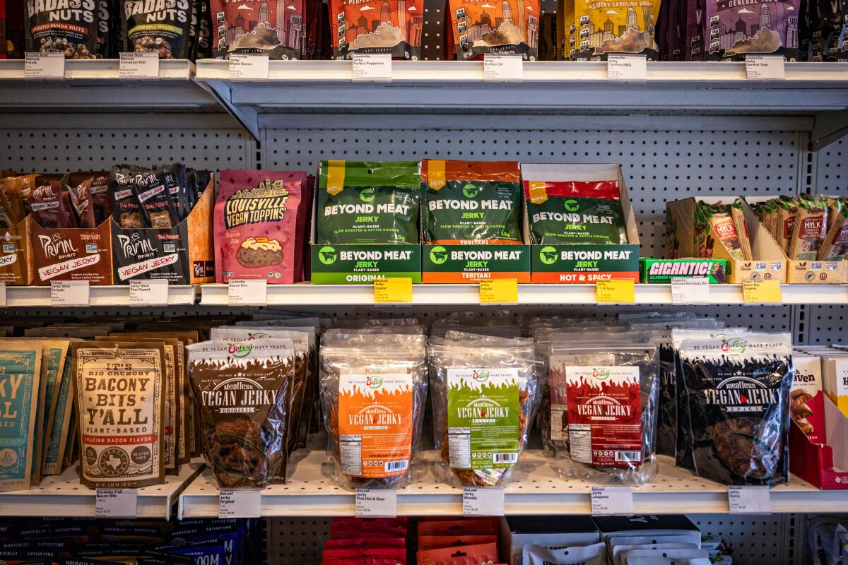Various types of vegan jerky on a grocery store's shelves.