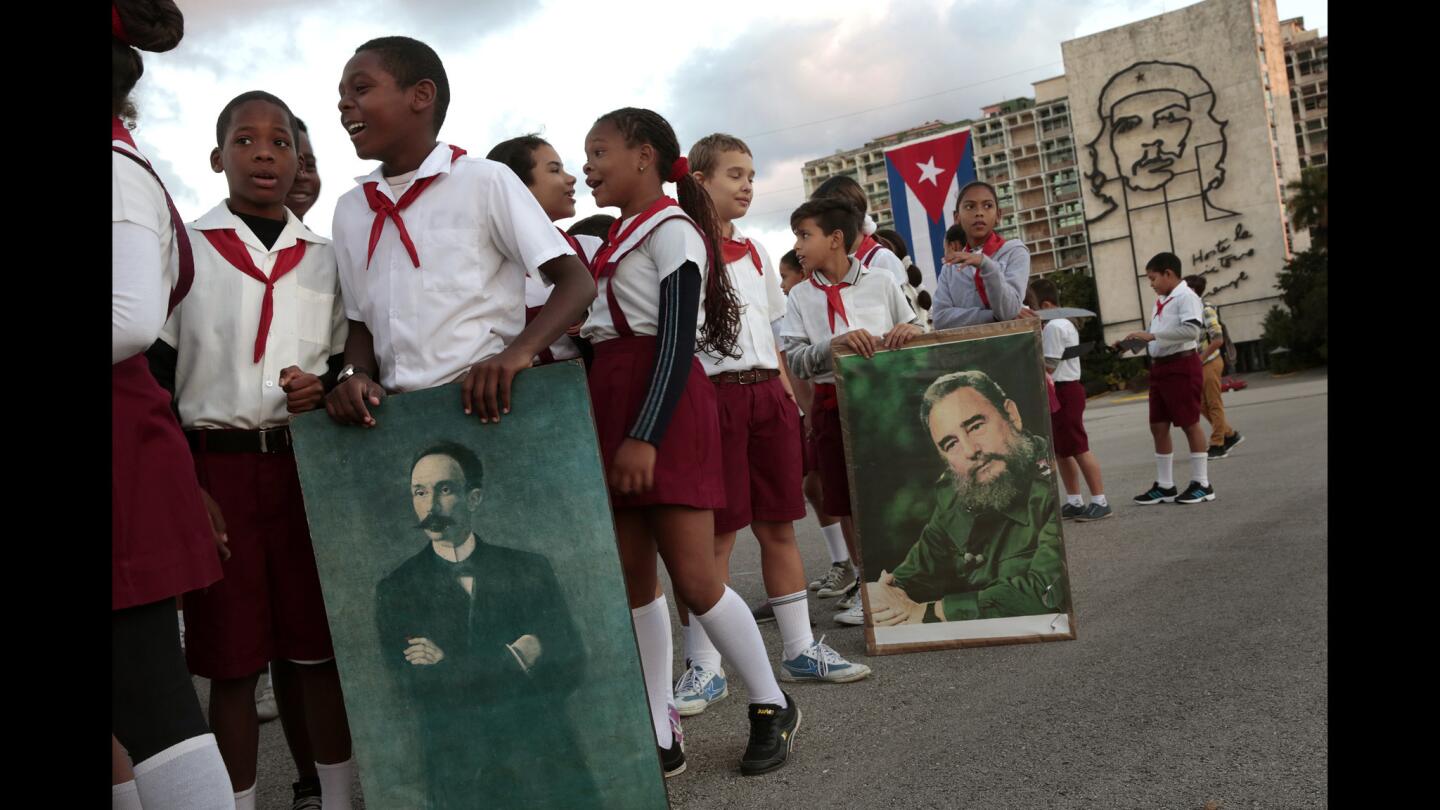 On the anniversary of the birth of Cuban national hero Jose Marti, schoolchildren in Havana hold images of Marti and Fidel Castro. Absent from public view is Miguel Diaz-Canel, likely successor to President Raul Castro.