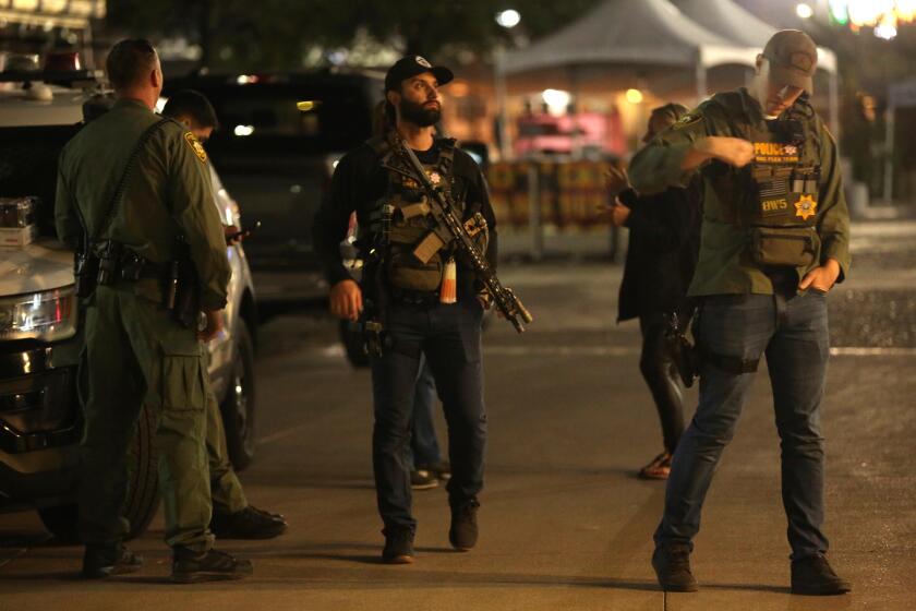 LAS VEGAS, NV - DECEMBER 6, 2023 - Police stand outside the Thomas & Mack Center where many UNLV students were brought after a mass shooting at the University of Nevada, Las Vegas on December 6, 2023. Three victims were killed and the shooter is dead. Another person is in critical condition. The shooting was reported around 11;45 a.m. at the Frank and Estella Beam Hall, home to the Lee Business School. (Genaro Molina / Los Angeles Times)
