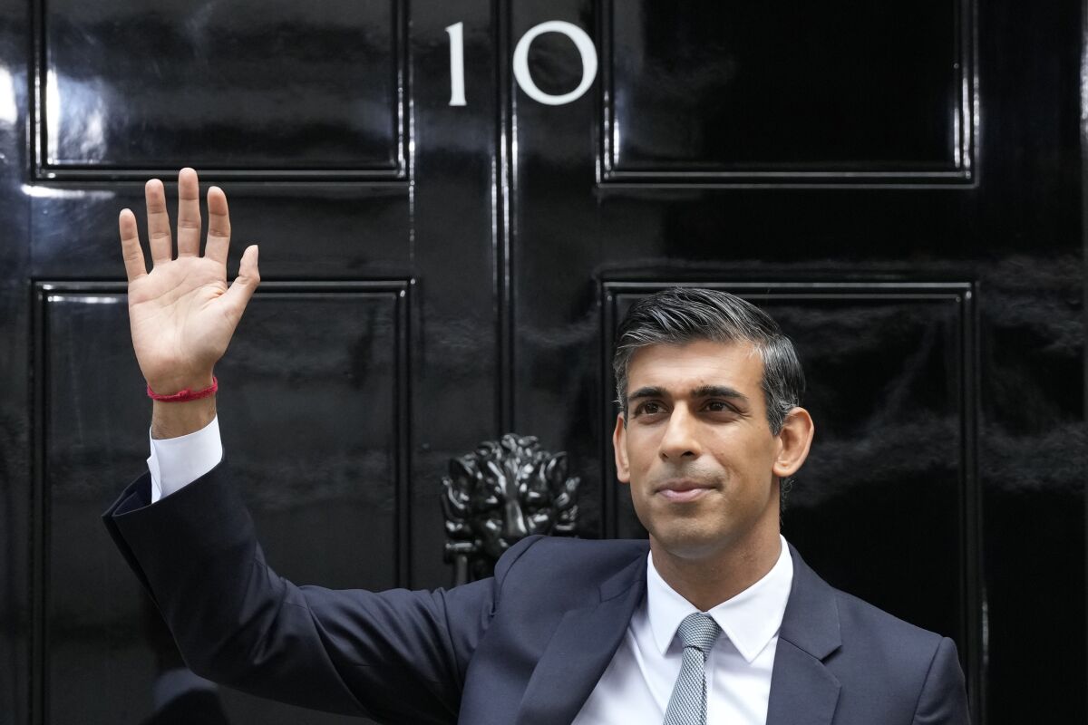 FILE - New British Prime Minister Rishi Sunak waves after arriving at Downing Street in London, Tuesday, Oct. 25, 2022, after returning from Buckingham Palace where he was formally appointed to the post by Britain's King Charles III. (AP Photo/Frank Augstein, File)