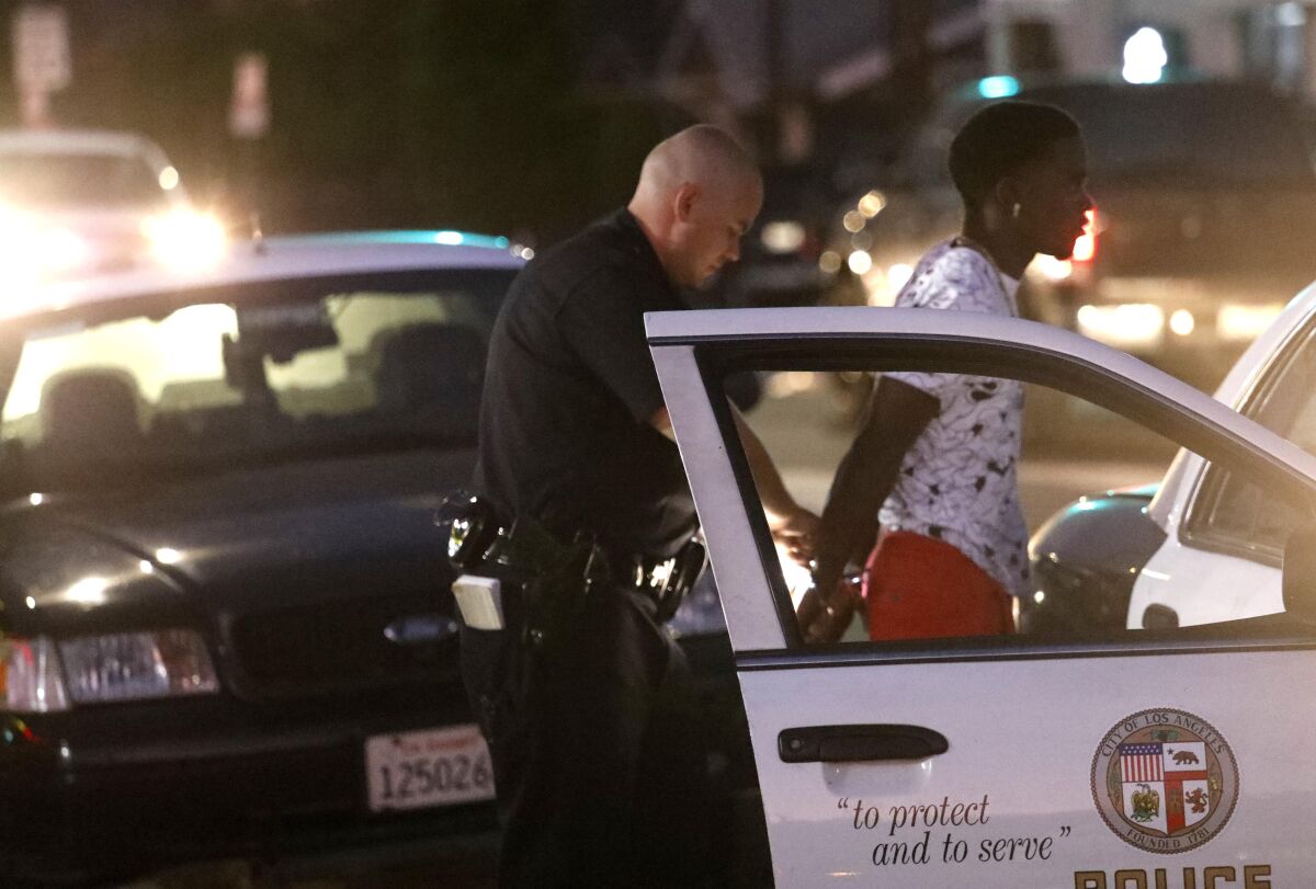 A police officer arrests a man