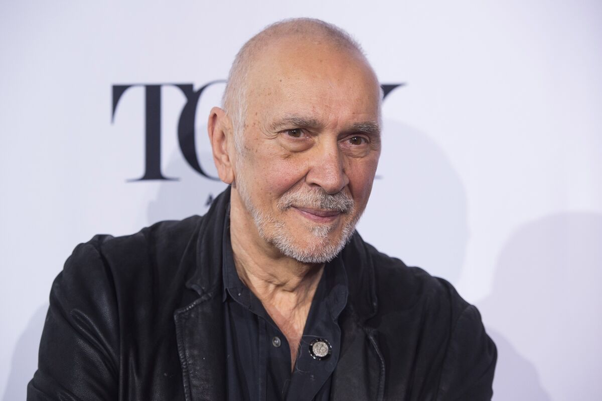 A balding man with a trim white beard