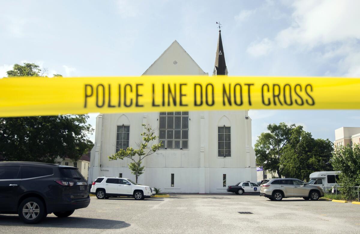 Police tape surrounds the parking lot behind Emanuel AME Church