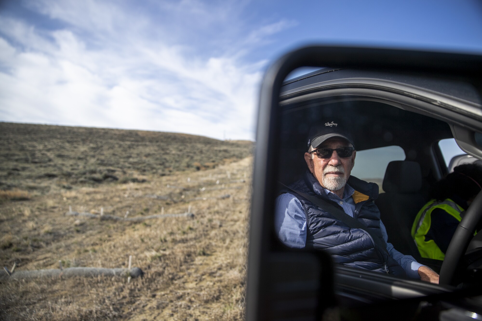 Bill Miller is reflected in a pickup truck's mirror at Overland Trail Ranch.