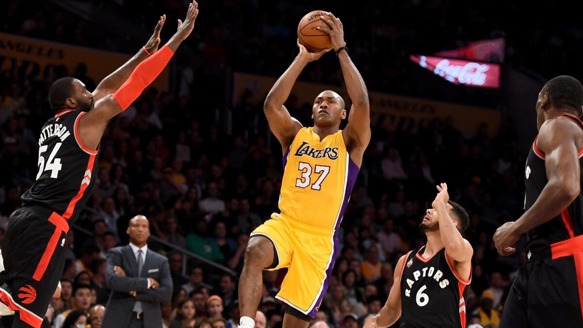 Lakers forward Metta World Peace shoots a floater in the lane against the Raptors on Friday night at Staples Center.
