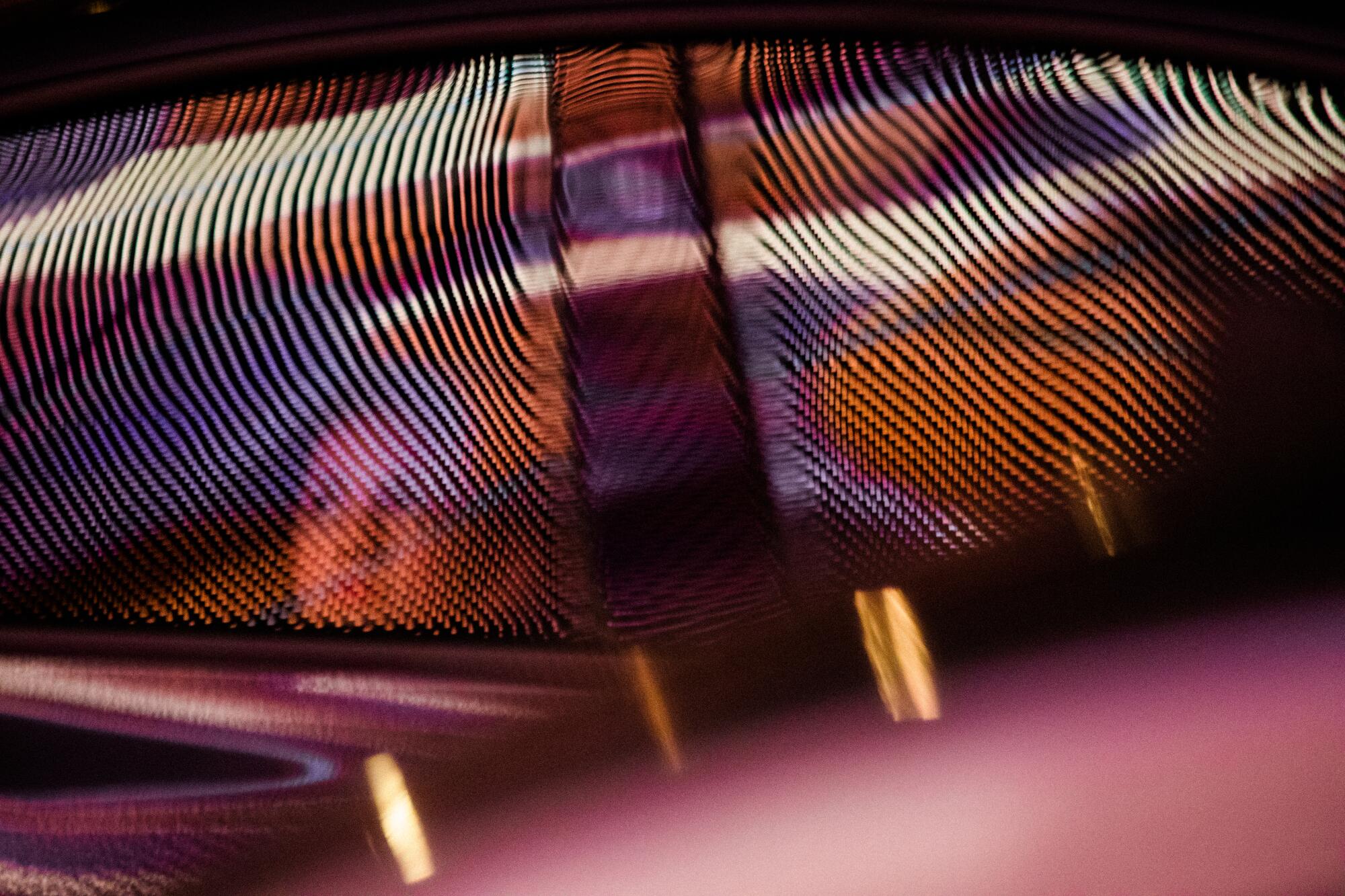 Sphere is reflected on the windshield of a passing car.