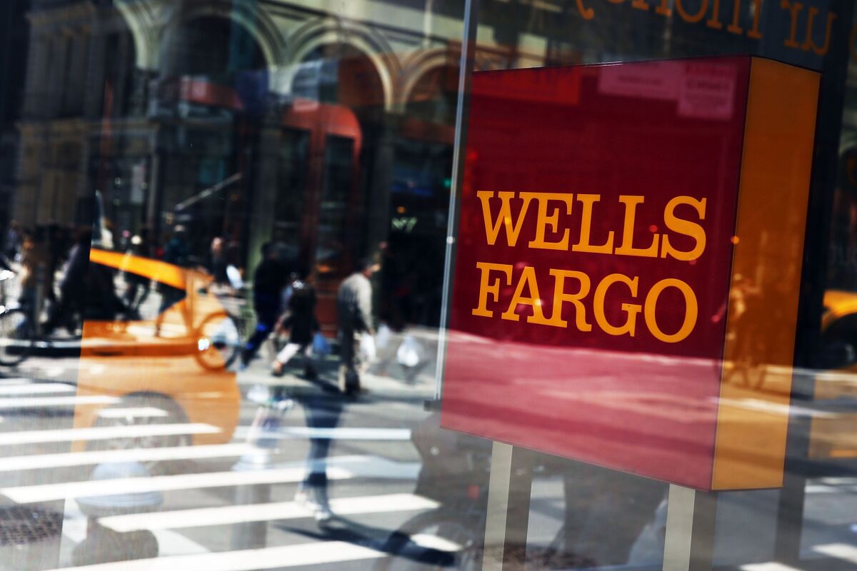 Pedestrians pass a Wells Fargo bank branch in Lower Manhattan on April 15 in New York City.