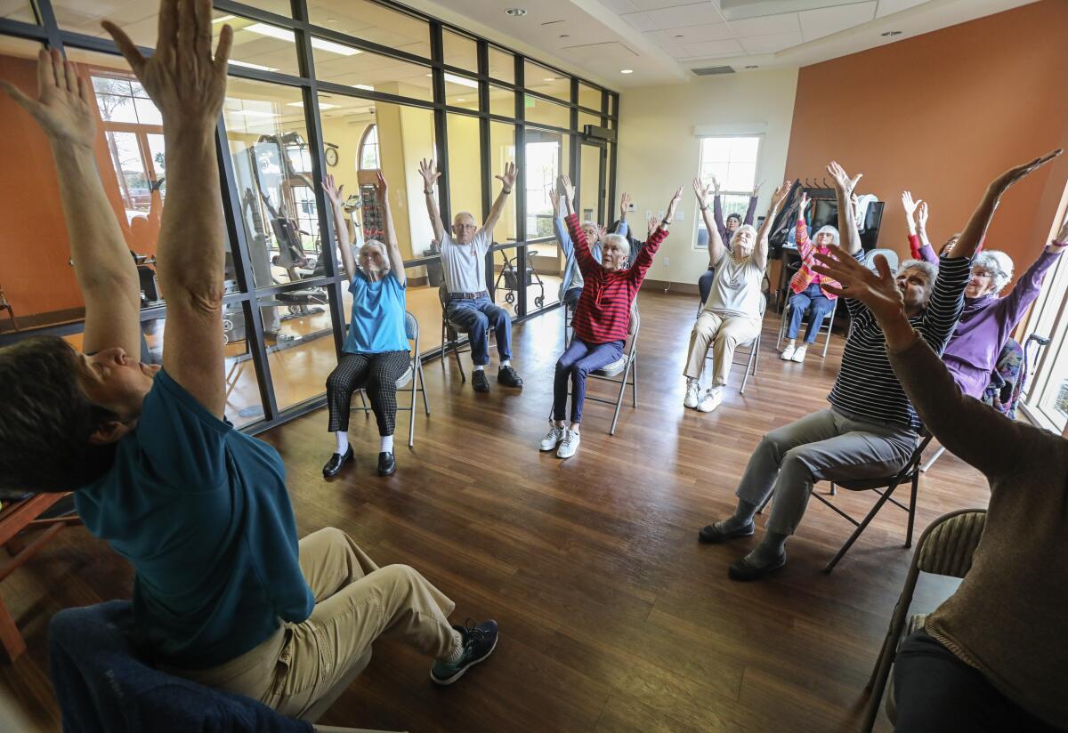 Residents at the St. Paul's Plaza independent and assisted living facility attend a gentle stretch class in Chula Vista.