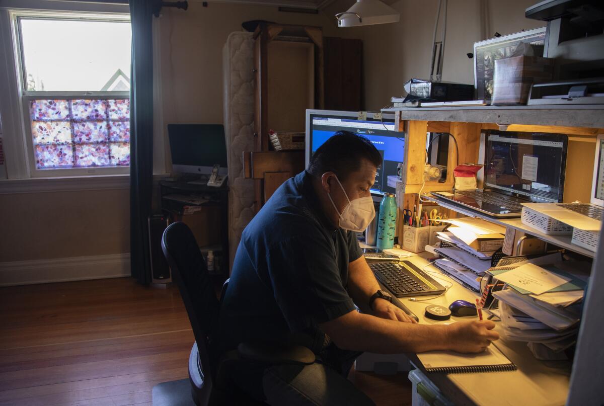 Oscar Marquez works at a desk.