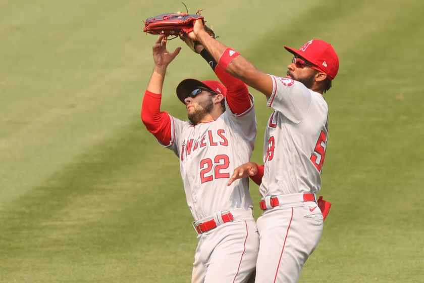 OAKLAND, CALIFORNIA - AUGUST 23: David Fletcher #22 and Jo Adell #59 of the Los Angeles Angels collide while catching a fly ball hit by Marcus Semien #10 of the Oakland Athletics in the sixth inning at RingCentral Coliseum on August 23, 2020 in Oakland, California. (Photo by Ezra Shaw/Getty Images)