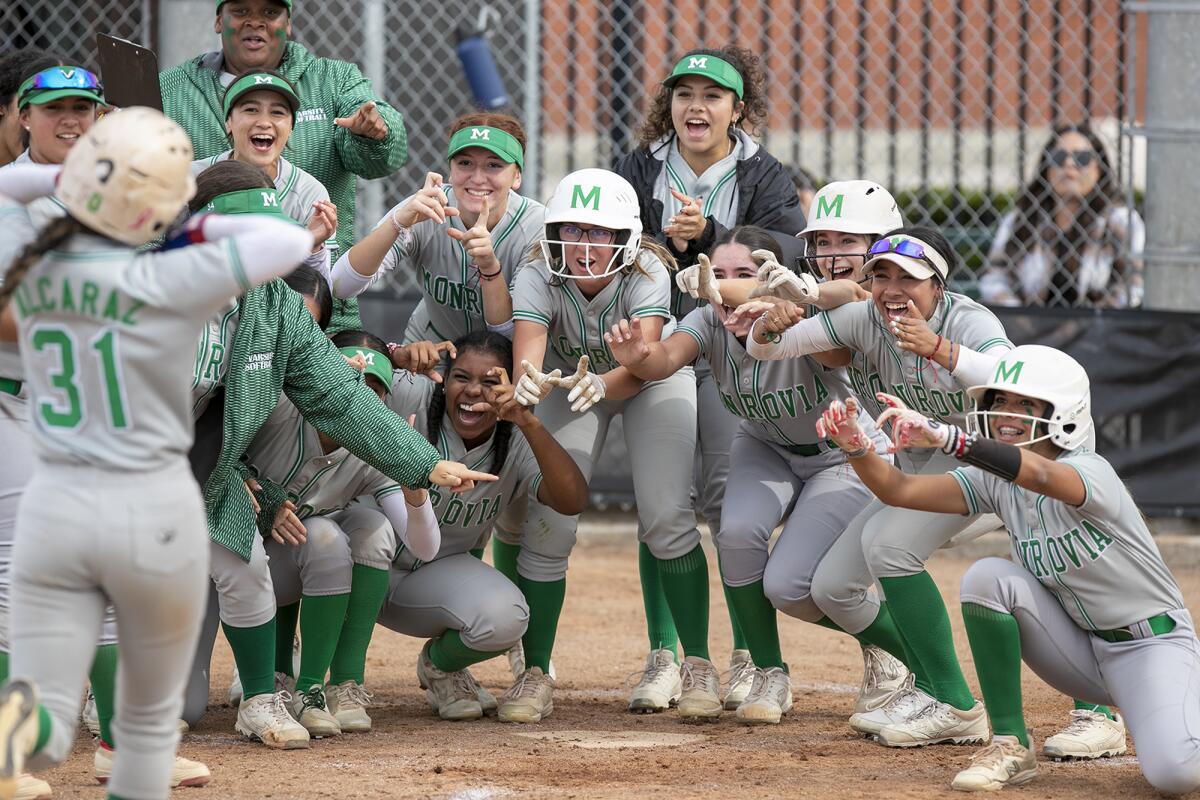Monrovia's Lucero Alcarez is greeted at the plate by her teammates.