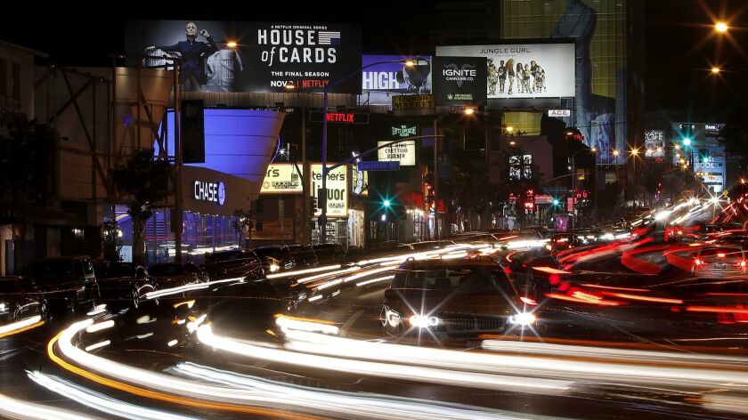 Cars drive along the Sunset Strip in West Hollywood on Oct. 10.