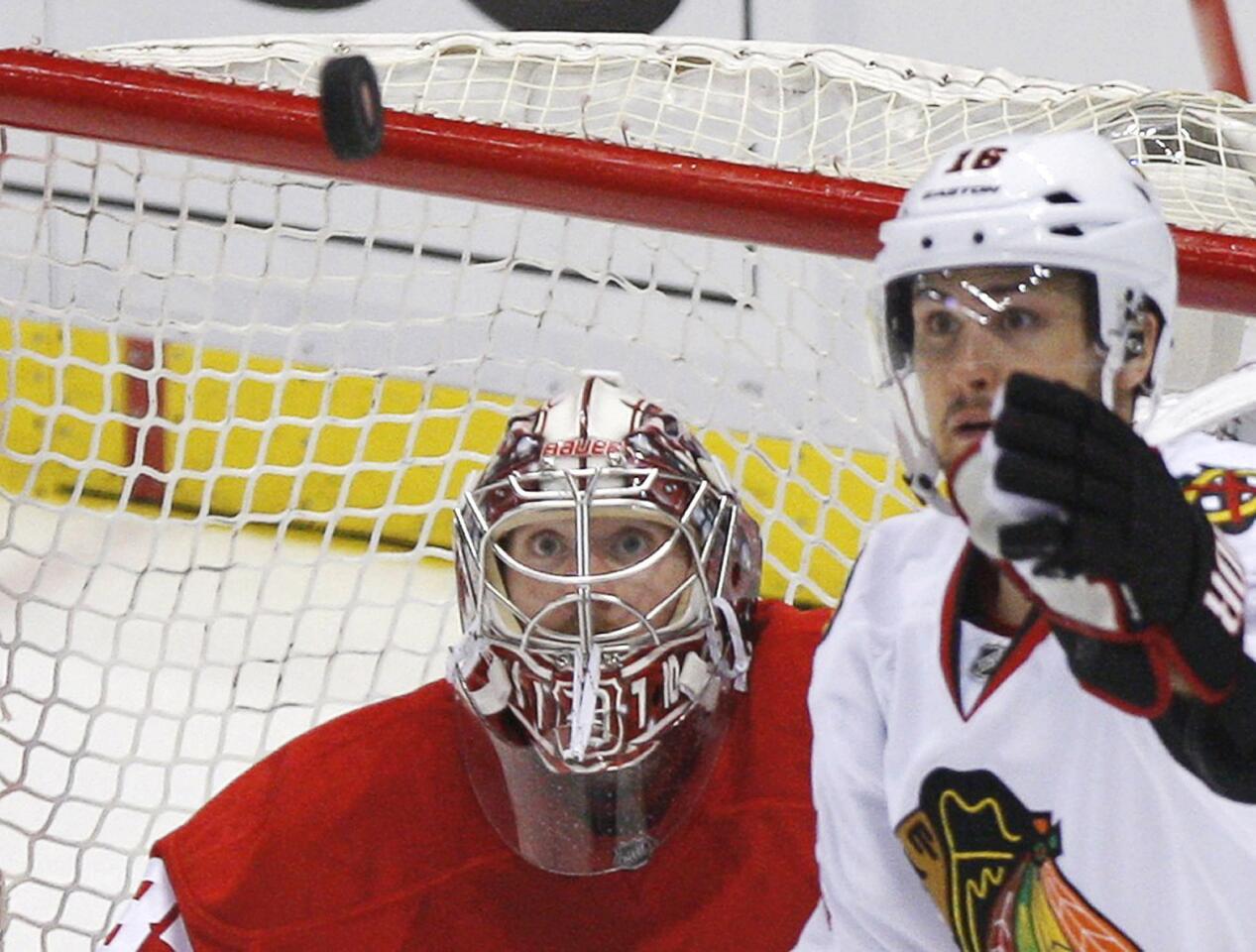 Detroit Red Wings goalie Howard keeps his eyes on the puck as Chicago Blackhawks' Kruger comes into the play during their NHL Western Conference semi-final hockey playoff game in Detroit
