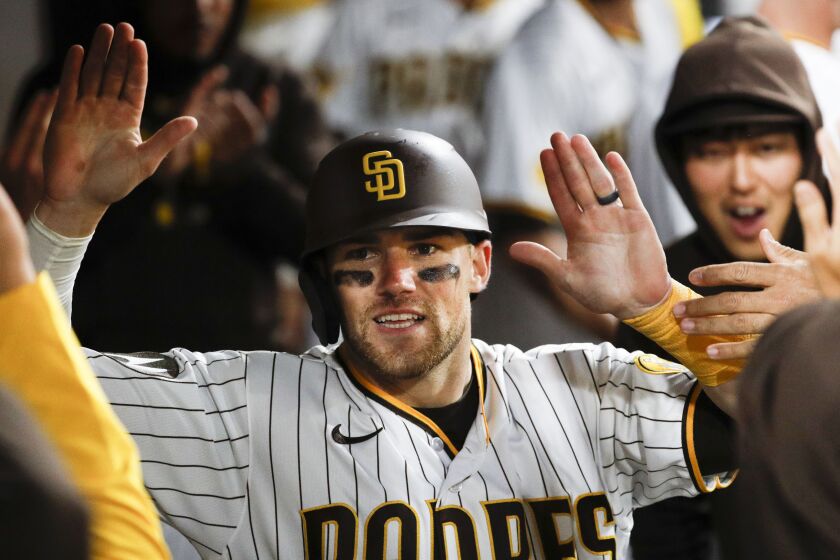 San Diego, CA - May 06: Padres catcher Brett Sullivan (29) gets high fives in the dugout after scoring a run against the Dodgers during the eighth inning at Petco Park on Saturday, May 6, 2023 in San Diego, CA. (Meg McLaughlin / The San Diego Union-Tribune)