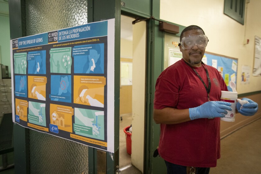 Assistant Plant Manager Tracy Westfield cleans John Burroughs Middle School on Tuesday in Los Angeles.