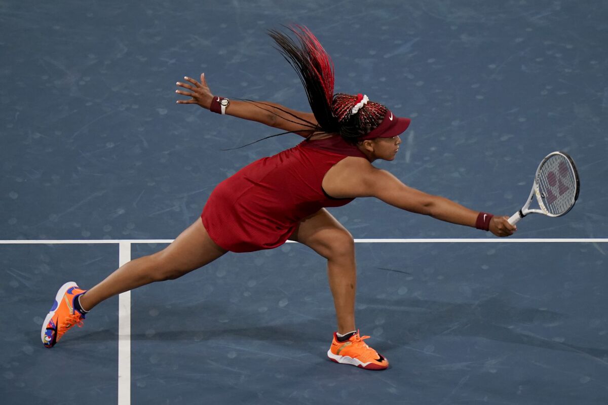 FILE - In this July 27, 2021 file photo, Naomi Osaka, of Japan, reaches for a shot by Marketa Vondrousova, of the Czech Republic, during the third round of the tennis competition at the 2020 Summer Olympics, in Tokyo, Japan. Osaka and Simone Biles are prominent young Black women under the pressure of a global Olympic spotlight that few human beings ever face. But being a young Black woman -- which, in American life, comes with its own built-in pressure to perform -- entails much more than meets the eye. (AP Photo/Seth Wenig, File)