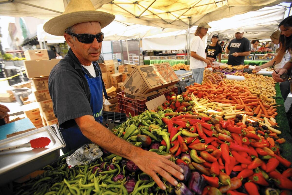 Alex Weiser of Weiser Family Farms at his stand in the Santa Monica Farmers Market. His family is in the initial stages of working with Fresh Nation, which is delivering farmers market goods through Amazon in the Southland.