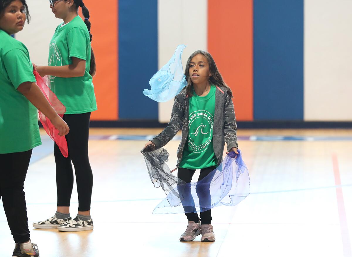 A participant performs in the scarf juggle at Oak View Elementary on Friday.