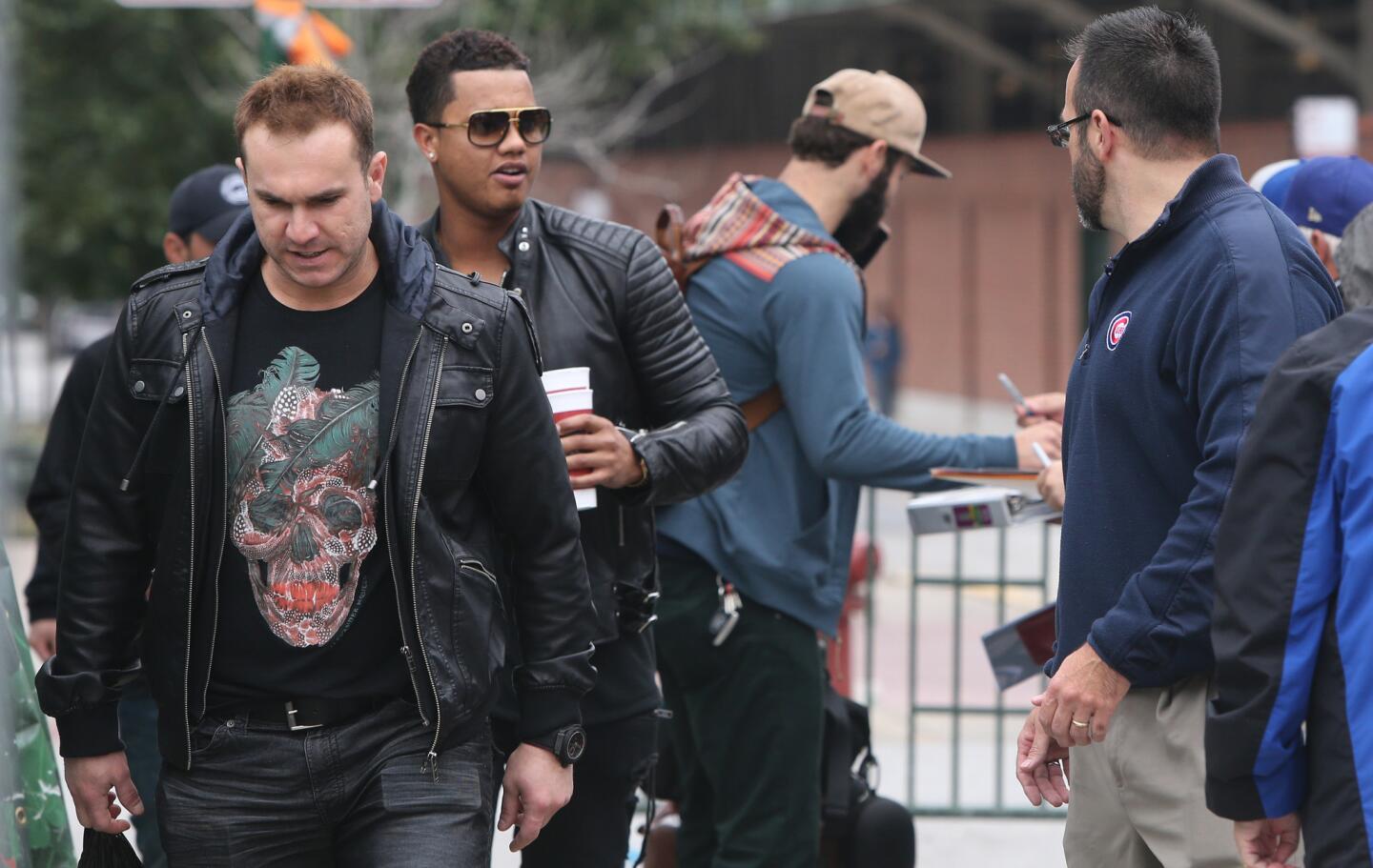 Miguel Montero and Starlin Castro arrive at Wrigley Field on Oct. 5, 2015, and board buses for a police-escorted ride to the airport and onto Pittsburgh for the wild-card game against the Pirates on Oct. 7.