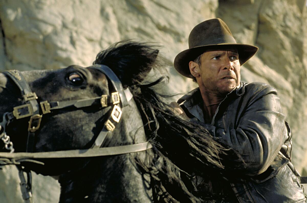 Harrison Ford as Indiana Jones riding a horse